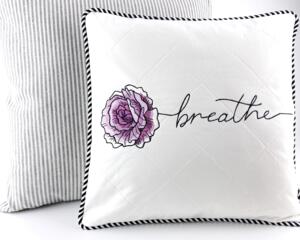 14" pillow embroidered with the word breathe as the stem of a purple rose stitched on white quilted fabric with black & white striped piping
