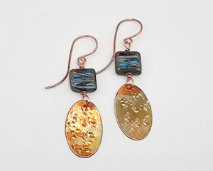 Handmade earrings with blue Czech glass square beads and flame-colored hammered copper dangles, 1.5 inches long.