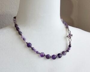 18 in long necklace - amethyst coin and charoite beads, glass tulip beads, and platinum plated cubic zirconia butterfly.