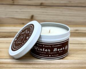 Pine and eucalyptus scented soy candle in 6oz tin with lid off.