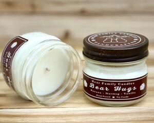 Banana bread scented soy candle in 4oz mason jar. One jar standing up with lid on and one jar on its side with lid off.