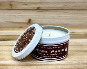 Fir tree scented soy candle in 6oz tin with lid off. 