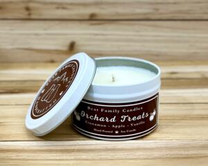 Apple cider scented soy candle in 6oz white tin with lid off.