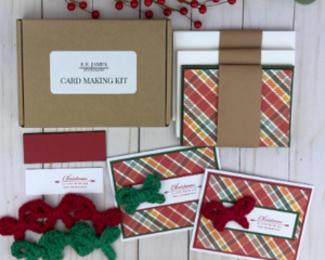 A handmade Christmas card kit with plaid scrapbook paper, cardstock, stamped sentiment, crochet bow embellishment and envelope for 6 cards.