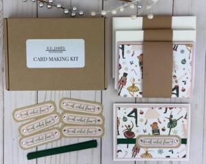 A handmade Christmas card kit with Nutcracker patterned scrapbook paper, cardstock, stamped sentiment, ribbon and envelope to DIY 6 cards.