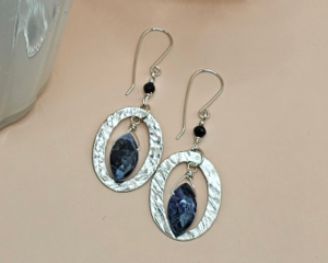 Dangle earrings with sodalite marquise stones and hand-hammered pewter ovals on Argentium silver ear wires.