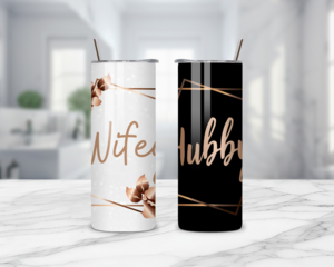 Close-up of “Hubby” on black tumbler with gold accents
“Wifey EST." tumbler in white with gold sparkle detailing
