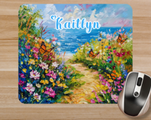 Close up of a personalized mouse pad. Beach pathway mouse pad personalized with a name and flowers and an ocean view design.
