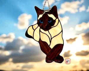 Siamese stained glass suncatcher- Brown and Cream in direct sunlight.