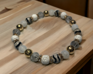 White lava rock and glass beads on a stretch cord.