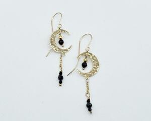 Handmade crescent moon earrings with blue sapphire beads dangling inside moon and on chain underneath