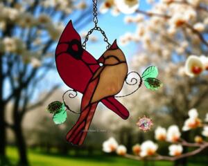Cardinal Love Stained Glass suncatcher by Robin C. Hary, made with red, amber, and rust glass. Accented with lamp worked leaves and copper wire.