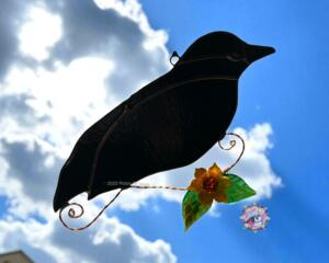 Crow Stained Glass Suncatcher by Robin C. Hary- made of black glass with lampworked sunflower and copper wire accents.