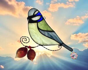 Eurasian Blue Tit Stained Glass Suncatcher by Robin C. Hary- made with pale yellow, light blue, dark blue and white glass. Accented with lampworked leaves and copper wire.