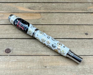 White fiberglass rollerball pen with custom bent watch parts. 