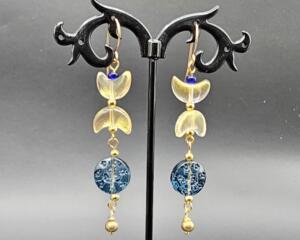 Handmade celestial earrings with crescent and deep-blue glass beads, accented with steel spacer beads, 3 inches long.