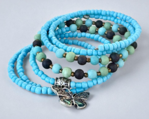 This handmade bracelet is made of turqoise blue seed beads as well as green and black beads.  I have added a butterfly charm.