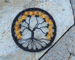 3 inch Halloween style tree of life. It is created with black wire and adorned with orange crackle beads