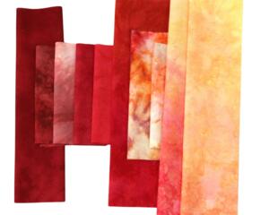 Hand dyed quilting cotton scrap bundle in shades of red, orange and yellow