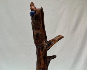 Front view with the burl-section and stone visible mounted on a vintage cast-iron lamp stand. 