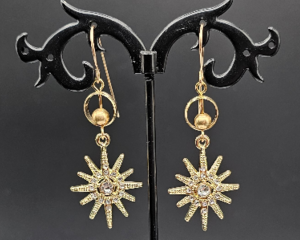 Earrings featuring gold plated star shaped dangles with rhinestones, stainless steel circle and bead accents, 14k gold filled wires.
