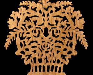 A handcrafted Victorian-style wooden Christmas tree ornament shaped like a basket filled with intricate floral designs, featuring detailed leaves and blossoms, with a small hook at the top for hanging.