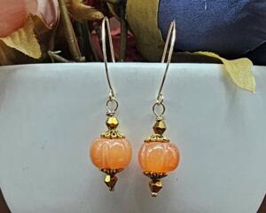 Festive handmade orange agate pumpkin-shaped earrings with gold accents and 14k gold-filled wires, about 2 inches long.