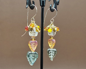 Handmade Czech glass leaf earrings with glass bicones in fall colors on 14k gold-filled wires, about 2 inches long.