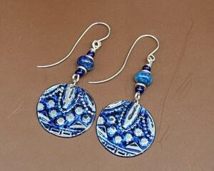 Handmade blue embossed pewter earrings with lapis lazuli beads and glass accents, just over 2 inches long.