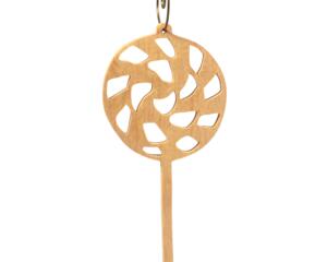 A handmade Christmas tree ornament crafted from light brown maple hardwood plywood, shaped like a lollipop with a round head featuring intricate spiral cutouts and a long stick handle, suspended from a small metal hook.