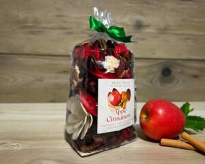 Apple Cinnamon Potpourri by Irish Twins. Bag with red and brown botanicals, a fresh apple, and cinnamon sticks.