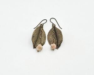 Handmade 2 inch long earrings with brass leaf dangle, mookaite beads in pinkish tone on brass chain, and nobium earring wires.