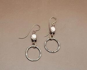 Handmade copper hoop earrings with mookaite beads and antique copper rings on brown background on handmade copper earring wires