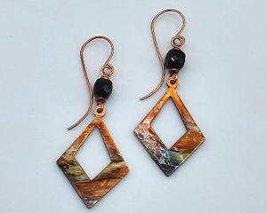 Handmade flame-colored copper earrings with diamond shaped copper dangles and tourmaline beads on handcrafted wires.