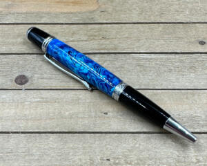 Multiple hues of blue resin on a chrome ballpoint pen