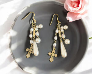 long dangle cross and pearl earrings.