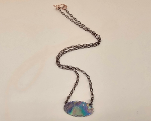 Handmade 16-inch copper necklace with flame-colored oval copper pendant in iridescent rainbow hues, hook clasp and copper chain.