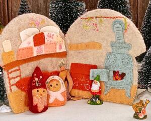 Handmade felt mushroom house quiet book with gnomes and accessories sewn onto ribbons for imaginative woodland play.