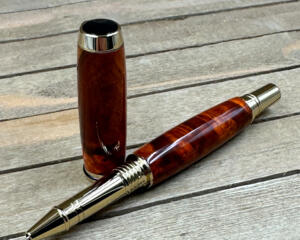 Red and brown colored burl wood with gold hardware 