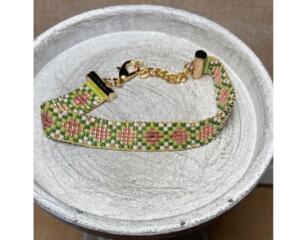  handcrafted loom-beaded bracelet with pink, green and white beads.