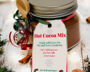 Hot Cocoa Mix Jar with festive red ribbon and pine sprigs, cozy handmade Christmas cocoa gift idea.
