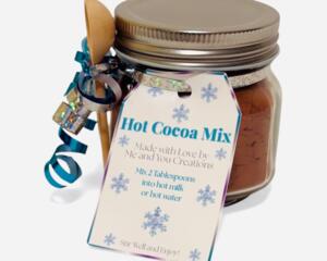 Winter Hot Cocoa Jar with blue ribbon, wooden spoon, and snowflake tag displayed on white background.