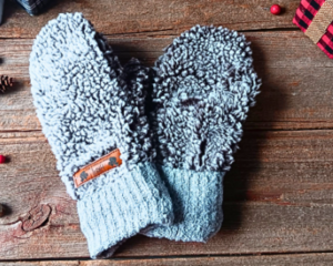 A cozy pair of teen, small woman’s handmade mittens crafted from fluffy gray fleece with silver gray ribbed cuffs; handmade and winter ready