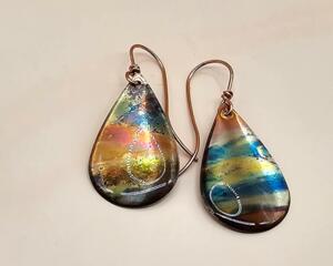 Handmade flame-colored copper teardrop earrings sealed with UV resin and handcrafted copper ear wires.
