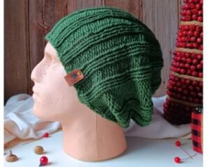 A hand knit acrylic beanie in evergreen green, in wide ribbed stitching. Ideal for adults & teens, it is crafted from soft cozy yarn.