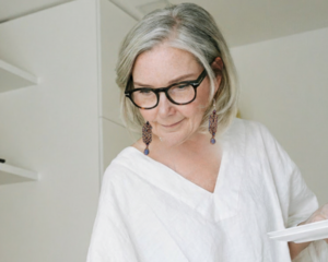 Midnight Iris Beaded Earrings featuring black and purple handwoven seed beads with iridescent blue teardrop accents.