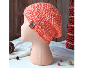 A hand knit acrylic & wool beanie in speckled pink & yellow with a textured stitch pattern. Ideal for adults and teens.