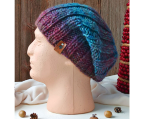 A hand knit acrylic & wool beanie in ombre blue & purple ribbing stretchy stitch pattern. For children and preteens ages 10, 11, 12, 13, 14.