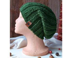 A hand knit green acrylic beanie in a ribbing stretchy stitch pattern. For winter holiday gifting for kids ages 10, 11, 12, 13, 14.