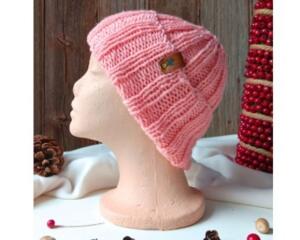 A hand knit pink wool beanie with a ribbing stretchy stitch pattern. For children and preteens ages 10, 11, 12, 13, 14.